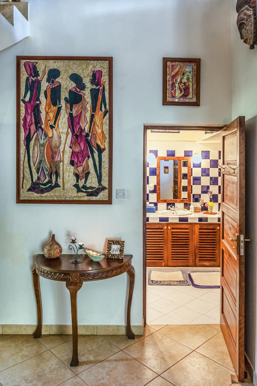 Hallway with African batik art and en-suite bathroom