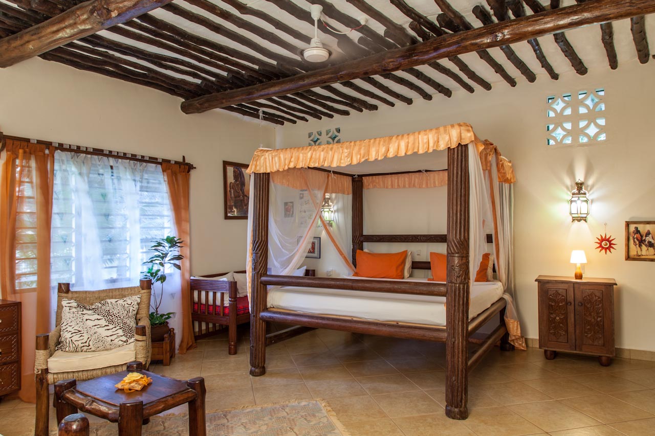 Spacious bedroom with hand-carved four-poster bed
