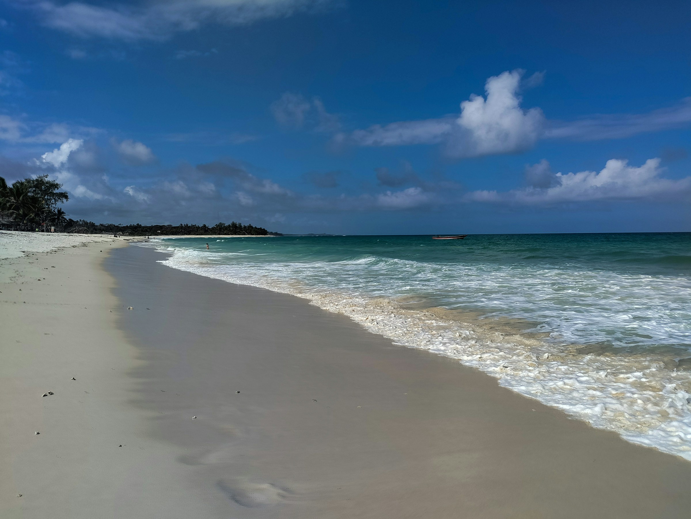 Clear blue Indian Ocean water lapping Diani's white sand
