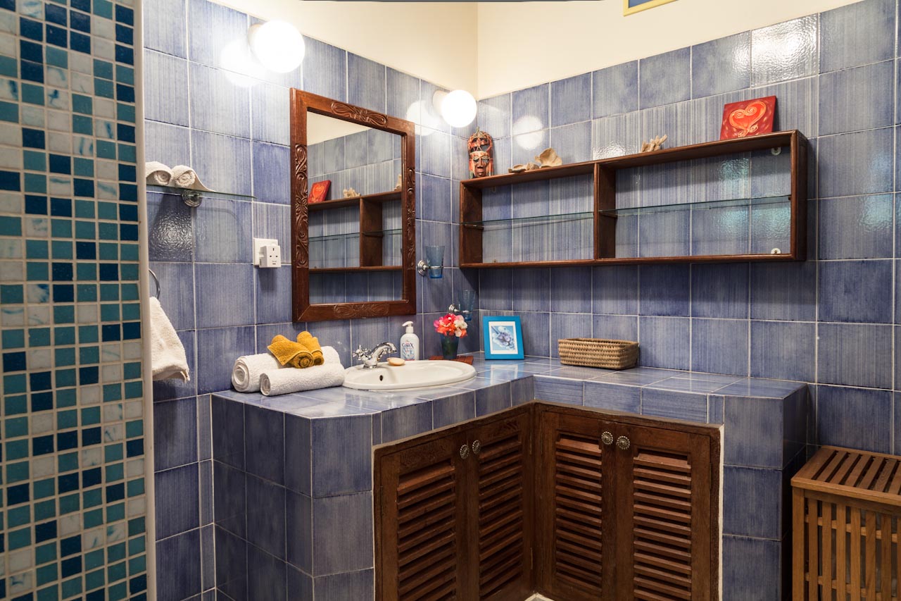 Blue-tiled bathroom with mosaic shower