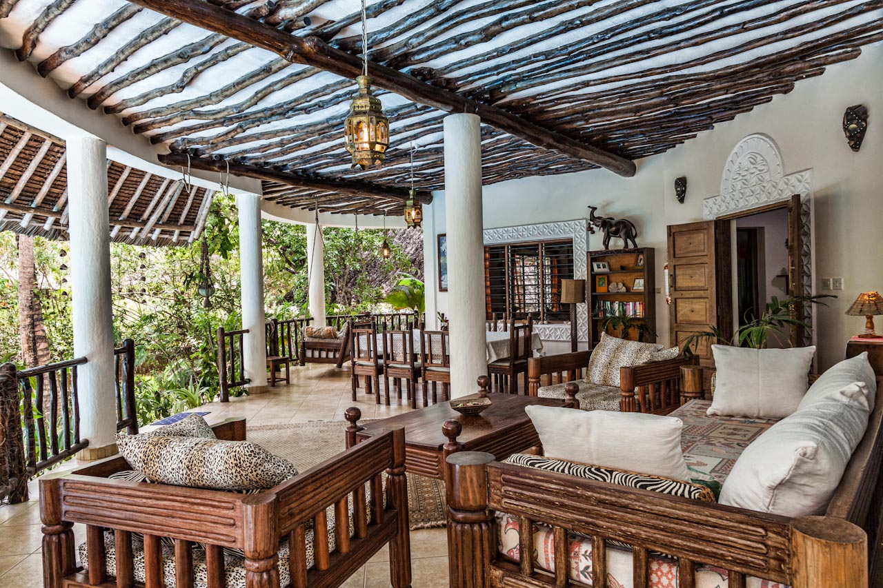 Wide covered veranda with carved wooden seating